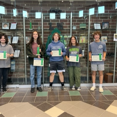 students smiling holding certificate